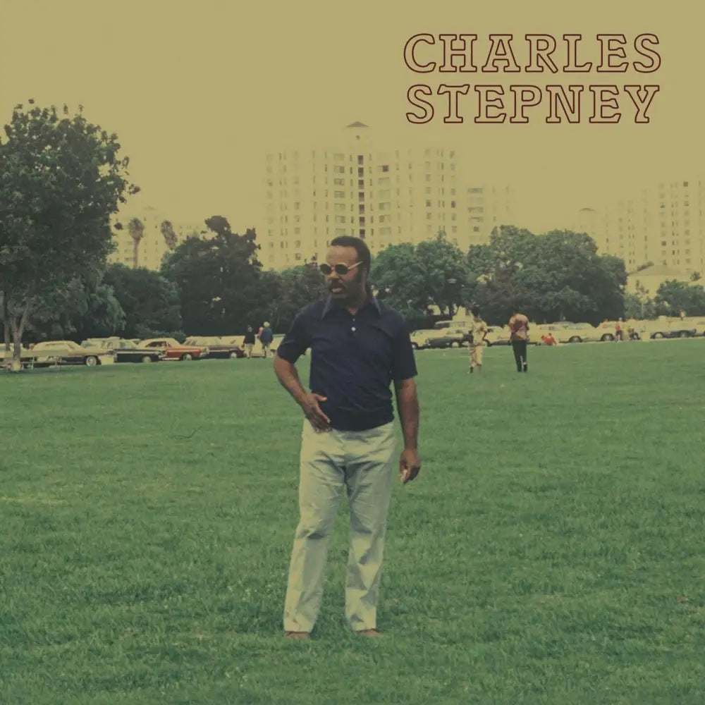 An album cover featuring a man standing in a grassy field with ’CHARLES STEPNEY’ written at the top right.