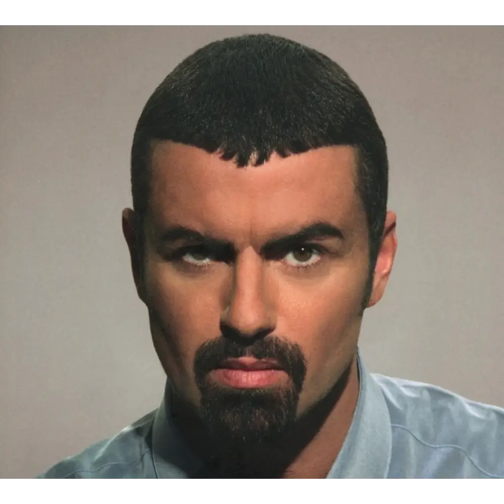 A man with dark hair, a mustache, and a goatee.