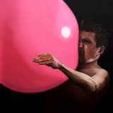 Man pushing against a pink balloon.