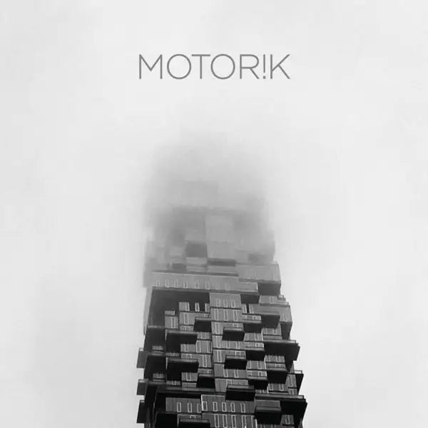 Modern skyscraper shrouded in fog.