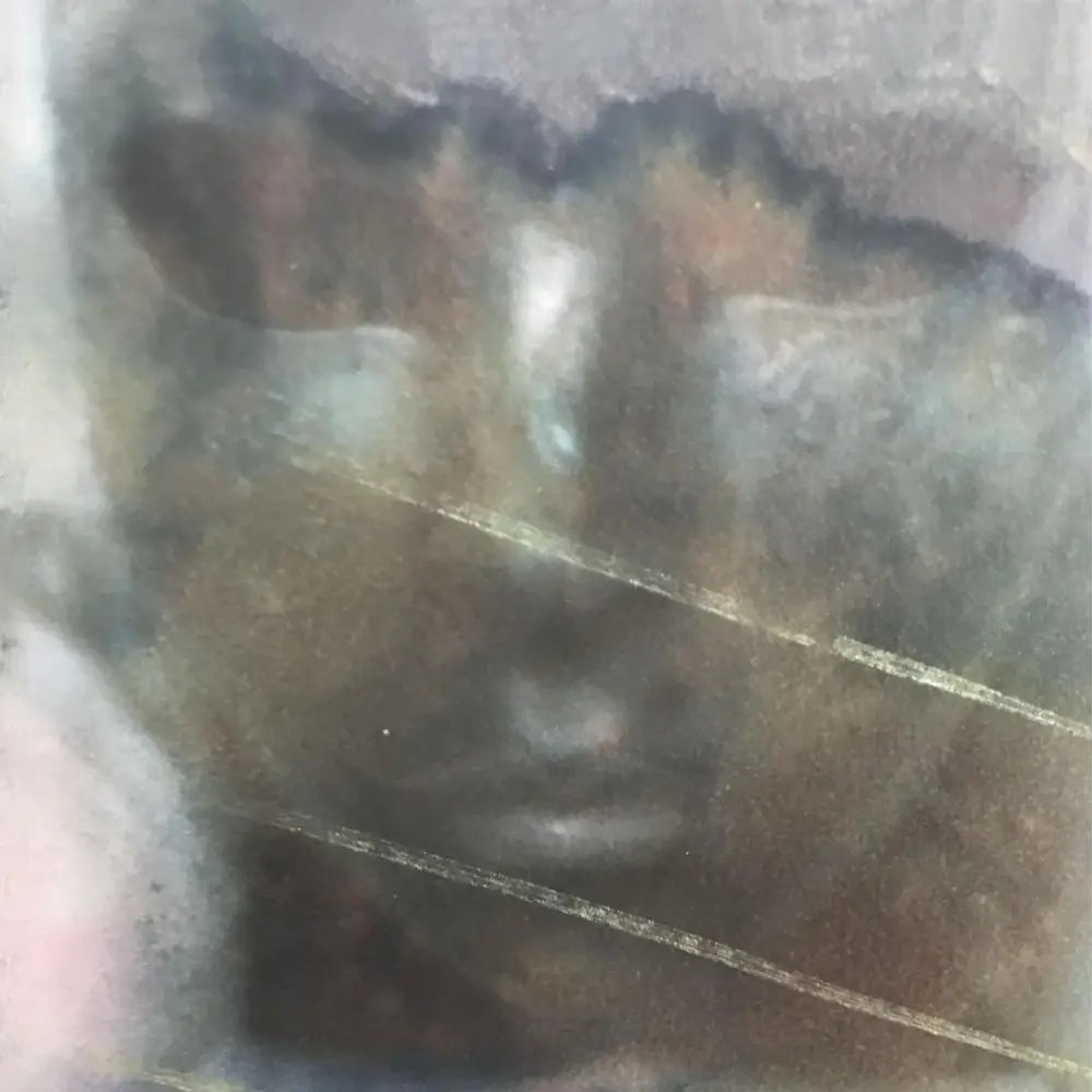 A dark, textured surface with faint, light-colored lines.