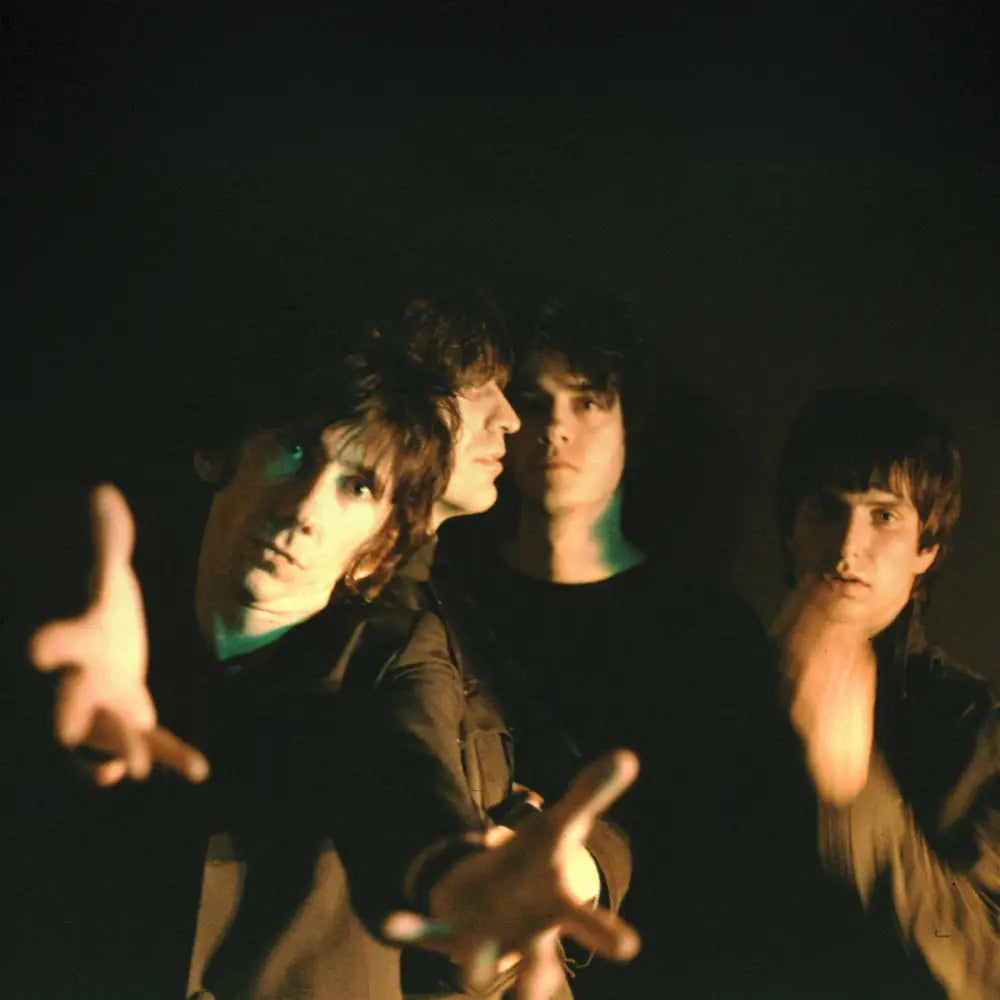 Four young men in dark clothing.