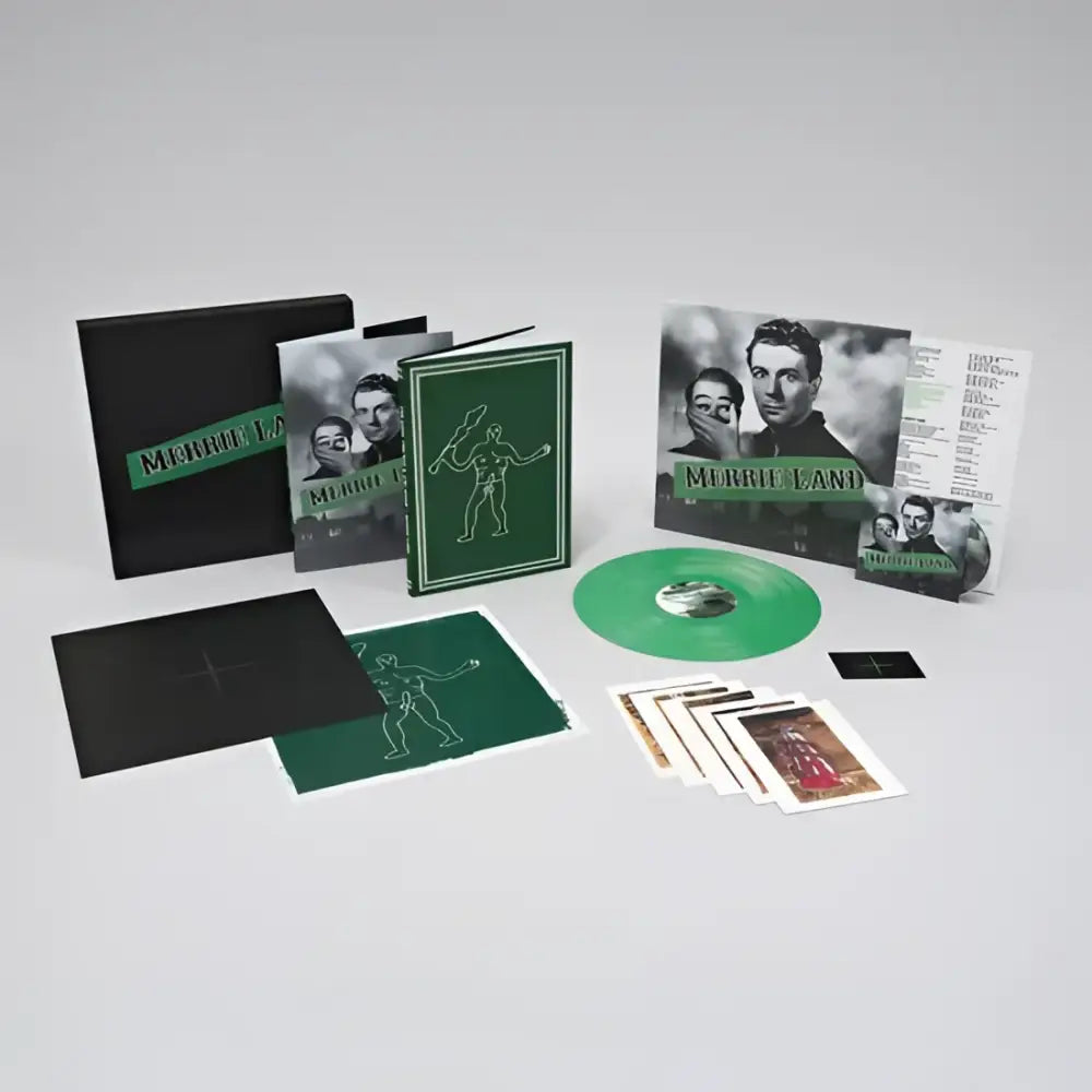 A collector’s edition music box set with a green vinyl record, books, and art prints.